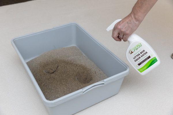 Litter Box Odor Eater product being sprayed to a cat litter box to remove odor